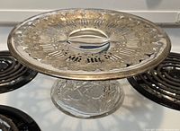 Angled top view displaying the silver plated tray surface with intricate cutout patterns and some tarnish.