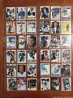 Photo showing full lot of 36 Wayne Gretzky hockey cards laid out in 6 rows and 6 columns with various team and trophy images.