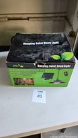 Box of hanging solar shed light showing branding and product image.