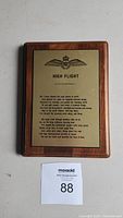 Front view of wooden plaque with engraved High Flight poem plate