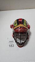 Front view of miniature goalie helmet with Tony Esposito autograph and Hall of Fame inscription.