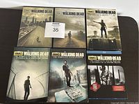Front view of six DVD cases of The Walking Dead, seasons 1-6 with cover art and AMC branding