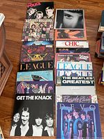 Overall view of two vertical stacks showing covers including The Police, Bay City Rollers, Aerosmith, The Human League Love and Dancing, The Mamas & The Papas, The Knack and portions of second stack