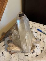 Front view showing two large quartz points and attached smaller crystals on base