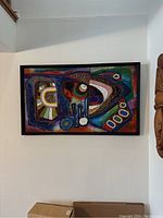 Full view of the rectangular abstract painting with wood frame hung on wall