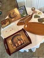 Overview of all trays, placemats, and coasters arranged on table, showing diverse styles and materials.