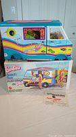 Side view of vintage Barbie's Beach Bus on original box with instruction pamphlet visible