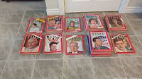 Photo showing multiple stacks of vintage TIME magazines spread on floor, each stack with various covers