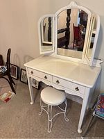 Full view of vanity table and stool from front
