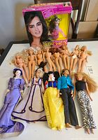 Lot of various fashion dolls including Brooke Shields doll in box, nude Barbie dolls, and other dressed dolls