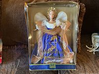 Full front view of Barbie Holiday Angel doll in damaged original box showing doll details and packaging state.