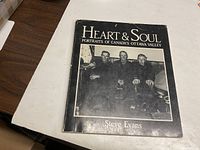 Front cover of the book showing the title, author, and a black & white photo of three elderly men.