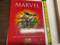 Front cover of Marvel Characters and Their Universe book showing Marvel superheroes and Marvel 75th Anniversary logo.