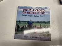 Front cover of the book showing title, subtitle, author, and a man standing with cattle in a field.