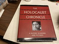 Front view of The Holocaust Chronicle book showing the title, cover photo, and subtitle.