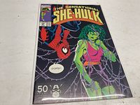 Front cover of The Sensational She-Hulk comic book issue 29 featuring She-Hulk and Spider-Man against a web background.