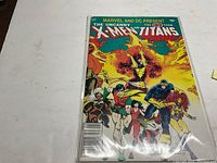 Photo of the comic book The Uncanny X-Men and Teen Titans #1 showing cover art with multiple superhero characters.