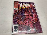 Front cover of Uncanny X-Men Comic #205 showing detailed red/organic tubing character art and Marvel branding.