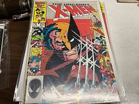 Front cover of The Uncanny X-Men comic book issue 211 showing Wolverine and other characters