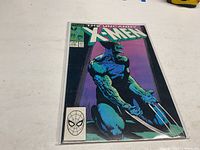 Front cover of The Uncanny X-Men comic book issue 234 showing a muscular character with claws in a sitting pose against a purple background.