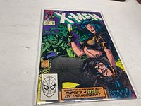 Front cover of Uncanny X-Men #267 comic book showing characters and vibrant cover art