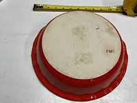 Bottom of the Emile Henry pie plate showing brand markings and color of the exterior.