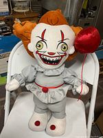 Front view of 20 inch Gemma Pennywise Clown plush doll holding a red balloon, showing facial details and outfit.