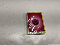 Front of the unopened Pink Fairy Energy Pokémon card showing the energy symbol.