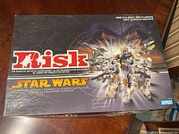 Closed Star Wars Risk game box showing Clone Wars themed artwork with Clone Troopers and galactic battle scene