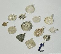 Overview of all charms laid out showing various designs and shapes