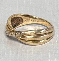Side view of bypass ring showing three overlapping yellow gold bands and five clear accent stones on one band