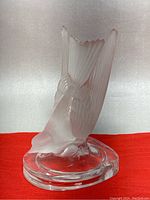 Side angle view showing bird etched details and clear oval base.