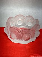 Front angle showing the frosted and clear crystal composition, circular and wave textured motifs, and scalloped edges of the bowl/ashtray.