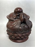 Front view of the Maitreya Buddha trinket box showing detailed carving and serene expression with hands in prayer position.