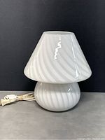 Front view of lamp showing base and shade swirl pattern