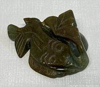 Top-down view showing detailed carving on jade fish ornament.