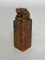Front view of the rectangular Shoushan stone seal showing dragon carving on top and engraved sides