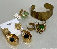 All three items: cuff with ring chain, dangle earrings, statement ring