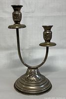 Front view of vintage 2-head silver candle holder showing engraved base and candle sockets.