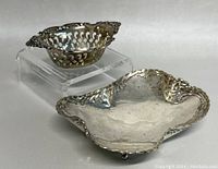 Both silver pieces displayed together from front, showing overall styling and scale