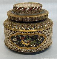 Front view of vintage Satsuma incense burner showing bird motif and patterned trims on ceramic body and lid.