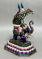 Side view of the hand painted enamel elephant figurine with howdah and rider, showing detailed enamel colors and bead decorations.