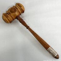 Full view of vintage wooden judge's mallet with sterling silver handle cover showing turned wood details and overall condition