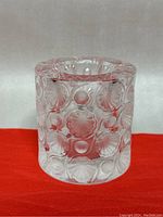 Front view of vintage Lalique crystal holder with Tokyo pattern of frosted and clear circular shell motifs.