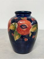 Front-facing view of vase showing full pomegranate motif