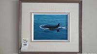 Photo of framed original acrylic painting showing the orca whale in water with mat and brown frame visible.