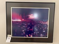 Framed photo art of a nighttime phototree event scene with crowd, black frame, white mat, signed by Robert Kwong.