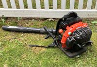 Full view of Echo backpack leaf blower on grass showing tube, engine housing and straps