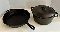 Photo of the skillet and Dutch oven side by side showing overall shape and finish.