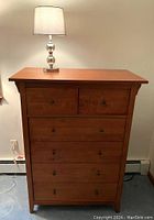 Full front view of chest and lamp against wall